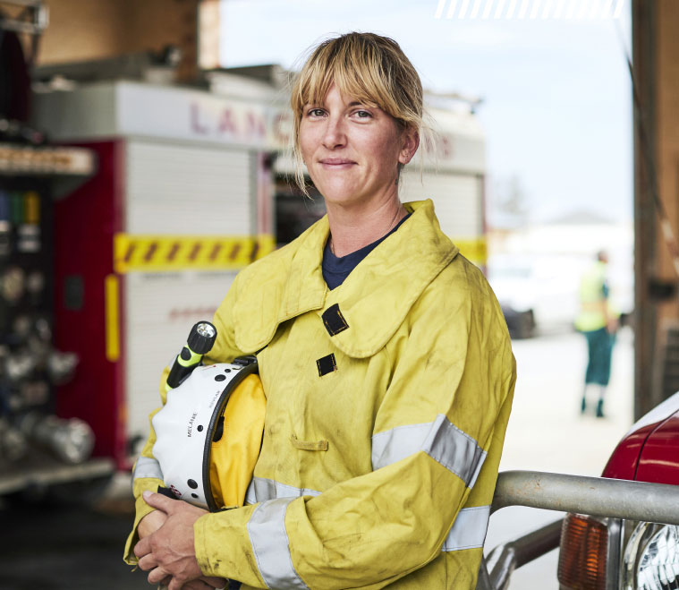 Female firefighter with fire truck